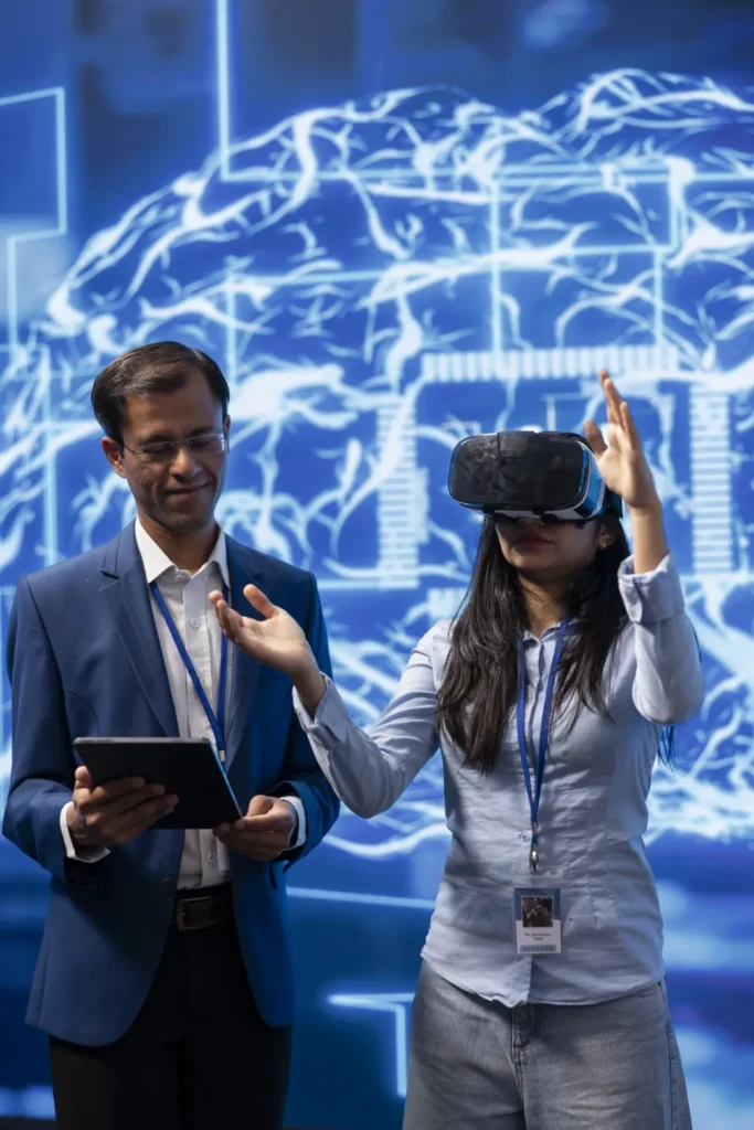 kobieta w okularach 3d, obok mężczyzna stoi i patrzy na tablet